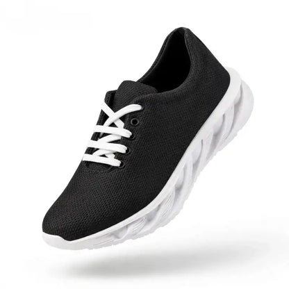 Black mesh-style men's sneakers with white laces and a white lightweight sole.