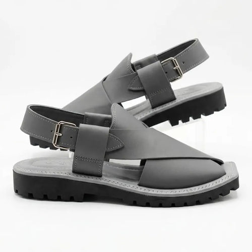 A pair of dark gray leather slingback sandals with chunky black lug soles, displayed on a clean white background.
