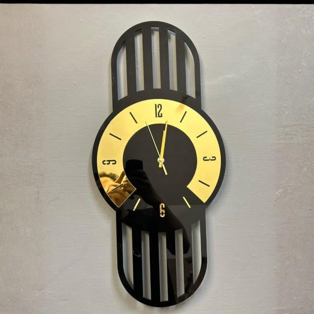 Wall clock with black and gold design on a plain background